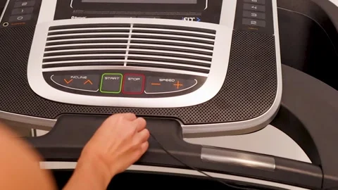 Close-Up of Hand Attaching Safety Key to Treadmill Console Stock Footage 325828266