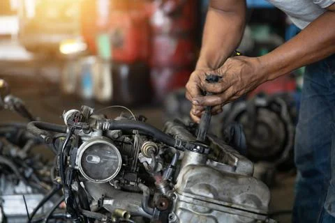 Close up hand of attractive man working hard and fix Auto mechanic on car e.. Stock Photos