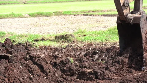 Close up hand of backhoe digging soil or ground on site of industry Stock Footage 217426130