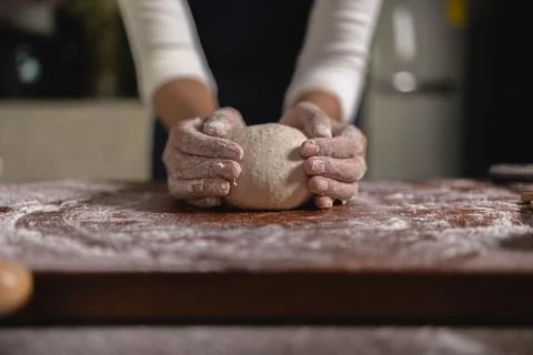 Close up Hand of baker chef is making with flour loaf of dough Stock Photos