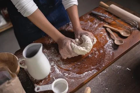 Close up Hand of baker chef is making with flour loaf of dough Stock Photos