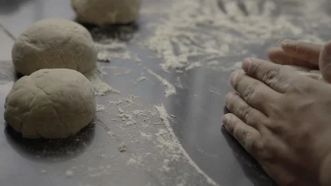 Close up Hand Baker Kneading Bread on a black table Stock Footage 272184432