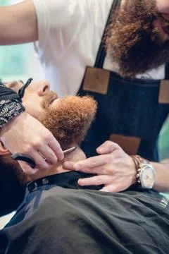 Close-up of the hand of a barber using scissors while trimming Stock Photos