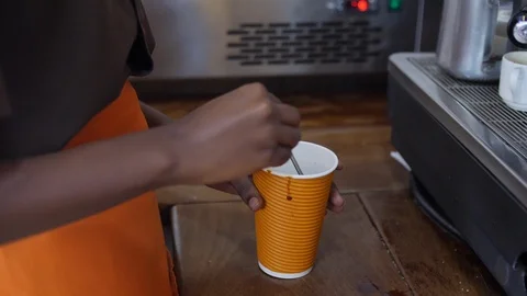 Close up hand of barista mixing sugar in coffee Stock Footage 116748053