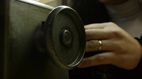 Close up of a hand begining to sew leather in an old leather machine Stock Footage 274415910