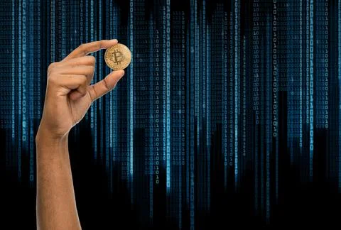 Close up of hand with bitcoin over binary code 写真素材