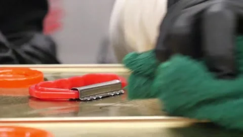 Close-up of Hand in Black Glove Cleaning Surface with Green Cloth Near Red Tool Video stock 343028131