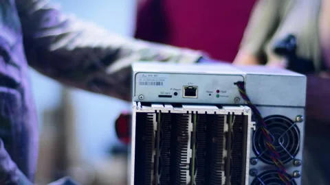 Close-up hand in black gloves maintaining an ASIC cryptocurrency BTC mining rig. Stock Footage 321267437