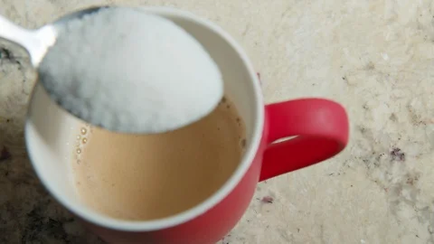 Close up hand Black Man Stirs Sugar Red Coffe Cup Stock Footage 128801516
