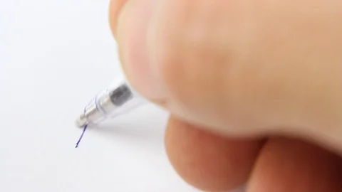 Close-up hand with blue ballpoint pen writes message love you 動画素材 126998736
