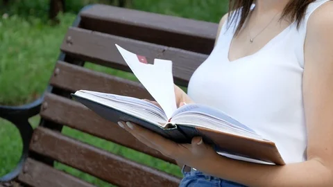 Close-up of the hand on the book is going to turn the page to the next chapter Video stock 100628857