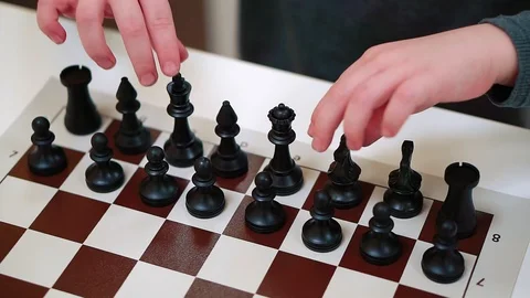 Close-up hand of a boy playing chess. Video stock 102593229