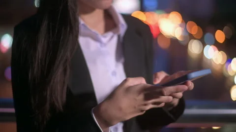 Close up hand of business woman is using smart phone in city over traffic lig Stock Footage 146126053