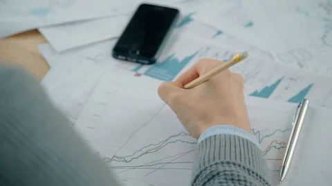 Close up hand of businessman working on graph with market situation at the table Stock Footage 90400690
