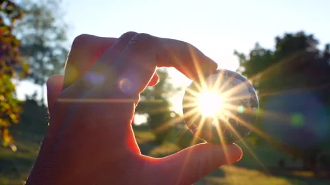 Close-Up of Hand Catching Sun Rays in 3D Globe Puzzle Pieces Stock Footage 295116390