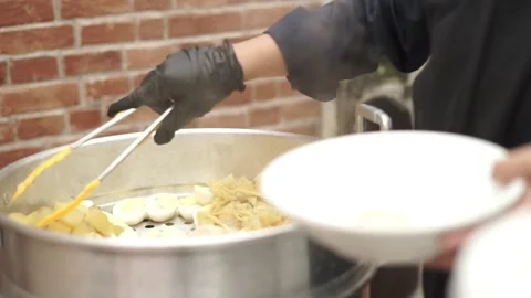 Close up hand of catering worker serving food into plate at celebration party Stock Footage 342223016