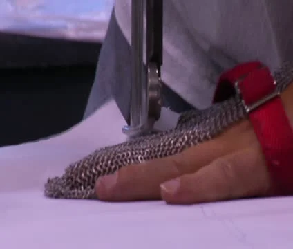 Close-up on hand with chain mail and cutting machine Stock Footage 21594128