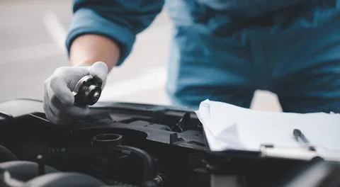 Close up hand checking car. Stock Photos