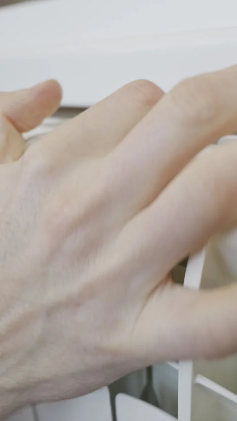 Close Up of Hand Checking Warm Radiator Indoors Stock Footage 330268610