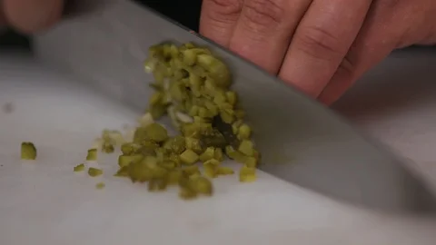 Close up hand chef hold knife cutting pickles cucumbers on wooden board Stock Footage 103290270