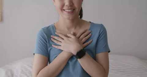 Close up hand on chest in good warm touch heart self love or hope. Stock Footage 159880863