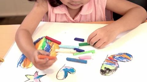 Close-up hand Children practicing drawing coloring on white paper. Stock Footage 164958895
