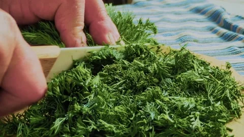 Close-up of a hand chopping fresh herbs Stock Footage 310176665
