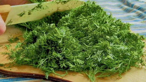 Close-up of a hand chopping fresh herbs Stock Footage 310176673