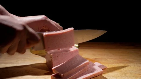 Close up hand chops canned ham Stock Footage 126303874
