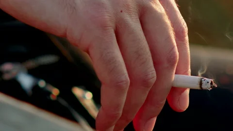 Close up of a hand with a cigarette Stock Footage 141866478