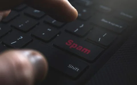 Close up of hand clicking Spam button. Internet concept for spam Stock Photos