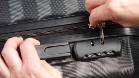 Close up hand close suitcase with combination lock. Hand entering code for .. Stock Footage 275592891