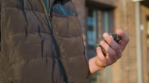 Close up of hand closing cigarette pack in front of building in sunlight Video stock 307067421