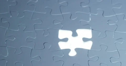 Close up of a hand completes a puzzle by putting the last missing piece Stock Footage 115284152