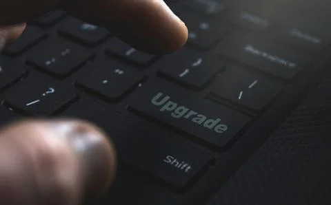 Close-up of a hand confidently selecting the 'Upgrade' option. Illustrating the Stock Photos