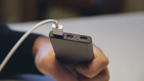 Close Up Hand Connecting USB Cable to Portable Power Bank Charger Stock Footage 333367387