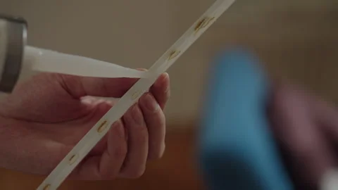 Close-up hand of construction worker applying liquid nails using silicone gun Stock Footage 306623056