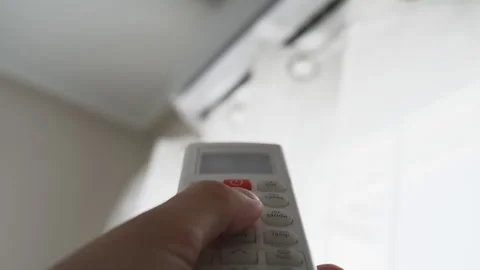 Close-up of hand controlling indoor climate with air conditioner remote, re.. Stock Footage 342762478