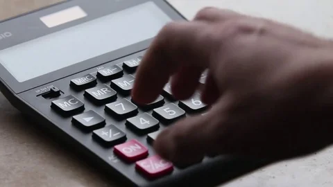 Close-up of a hand counting on a calculator Stock Footage 85186029