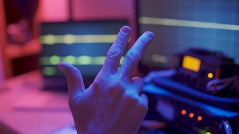 Close up hand counting down from 3 to 1 - TV show control room and monitors Stock Footage 129291907