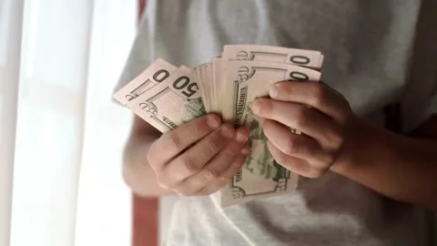 Close-up of a hand counting paper dollars. man counting dollar bills with b.. Stock Footage 266469387