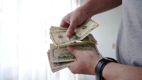 Close-up of a hand counting paper dollars. man counting dollar bills with b.. Stock Footage 266469756