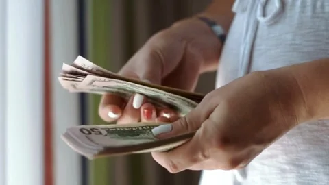 Close-up of a hand counting paper dollars. man counting dollar bills with both Stock-Footage 336259636
