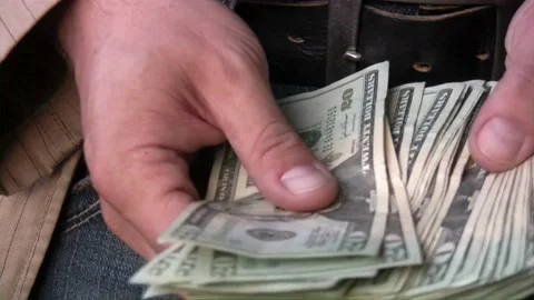 Close-up of a hand counting paper dollars. man counting dollar bills with both Stock-Footage 336260354