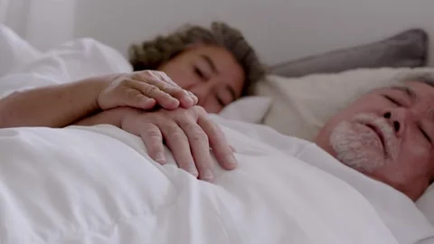 Close up hand couple elderly  holding hand and sleep on bed in bed room. Stock Footage 152933509