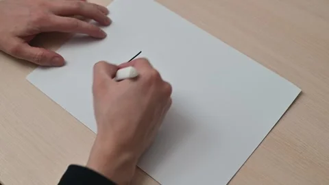 A close-up of a hand crumpling a piece of paper with the word START on it, 스톡 동영상 337550497