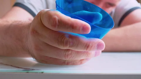 Close-up of a hand crushing an empty plastic cup Stock Footage 336206107