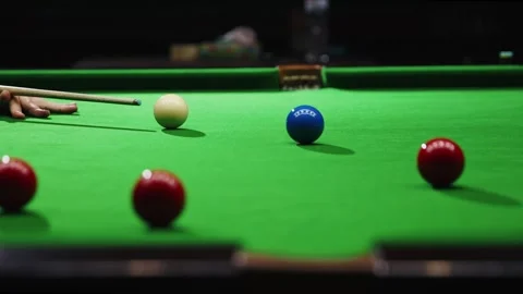 Close-up on hand cueing snooker ball, focus on red balls and green table. Event Stock Footage 266820878