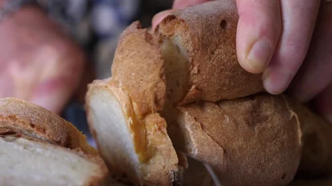 Close-Up of Hand Cutting Bread with Knife Stock Footage 279923906