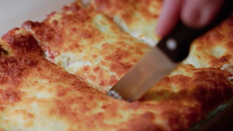 Close up of a hand cutting delicious lasagna Stock Footage 301734091